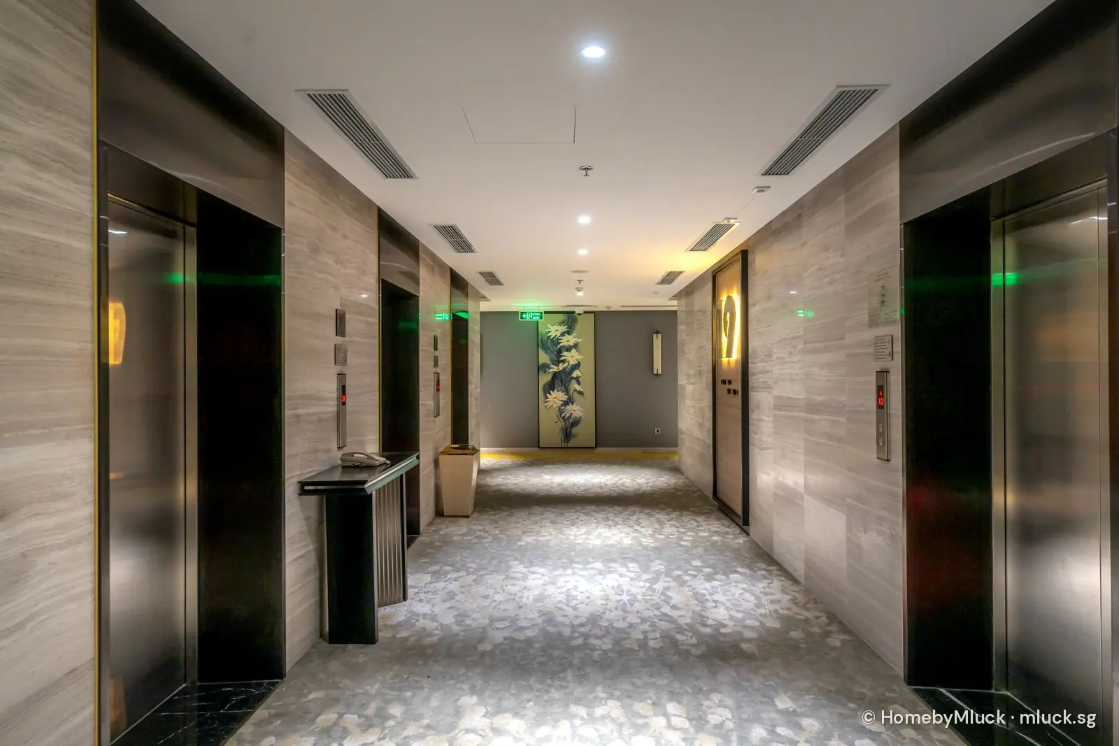 Bright modern hotel corridor with lift lobby