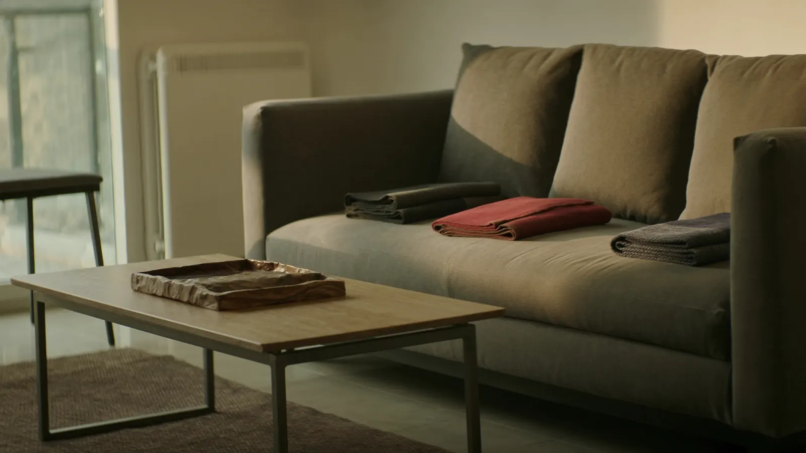 Sofa throws folded and squared in a guest-ready living room